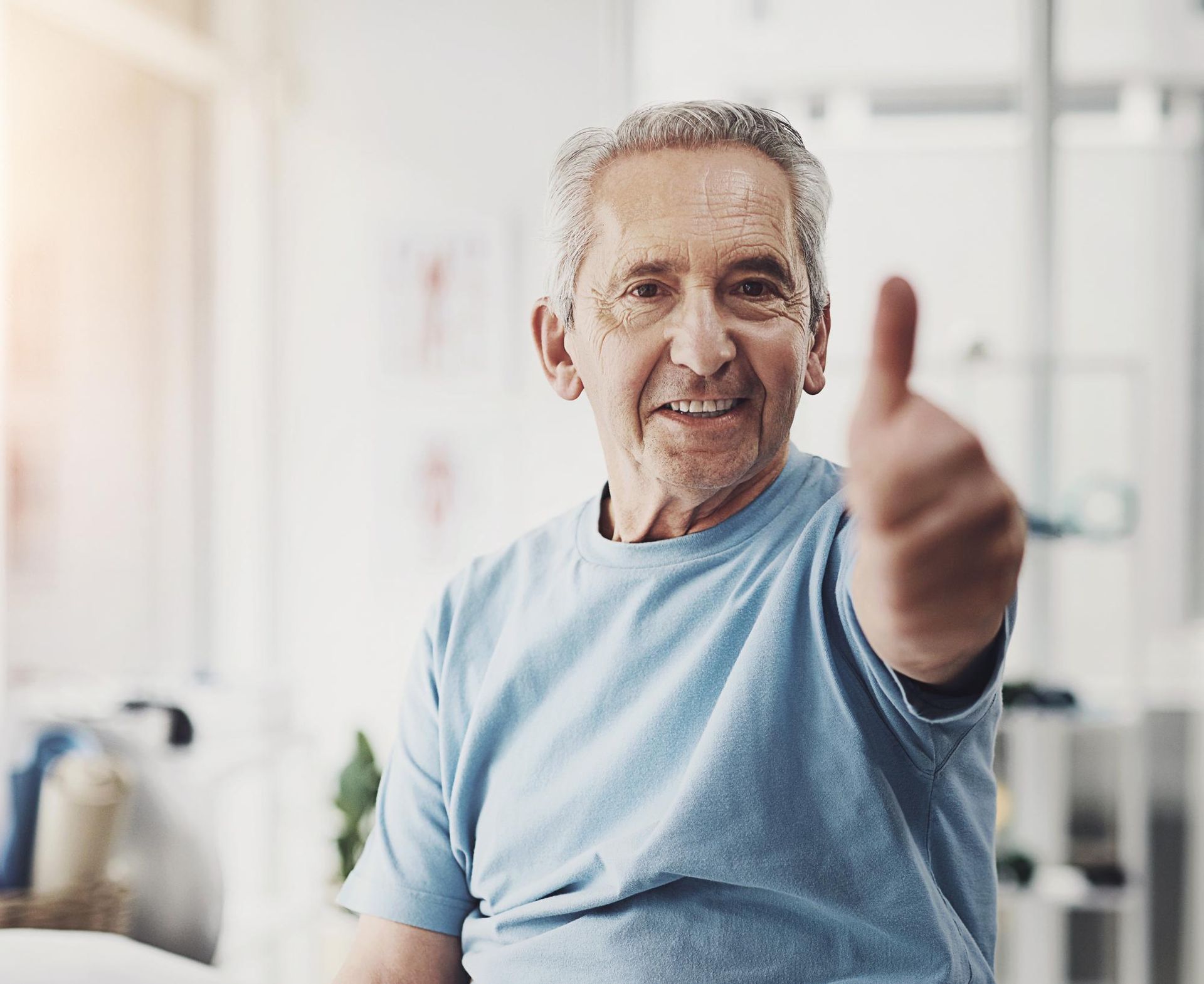 Resident with caregiver giving a thumbs up